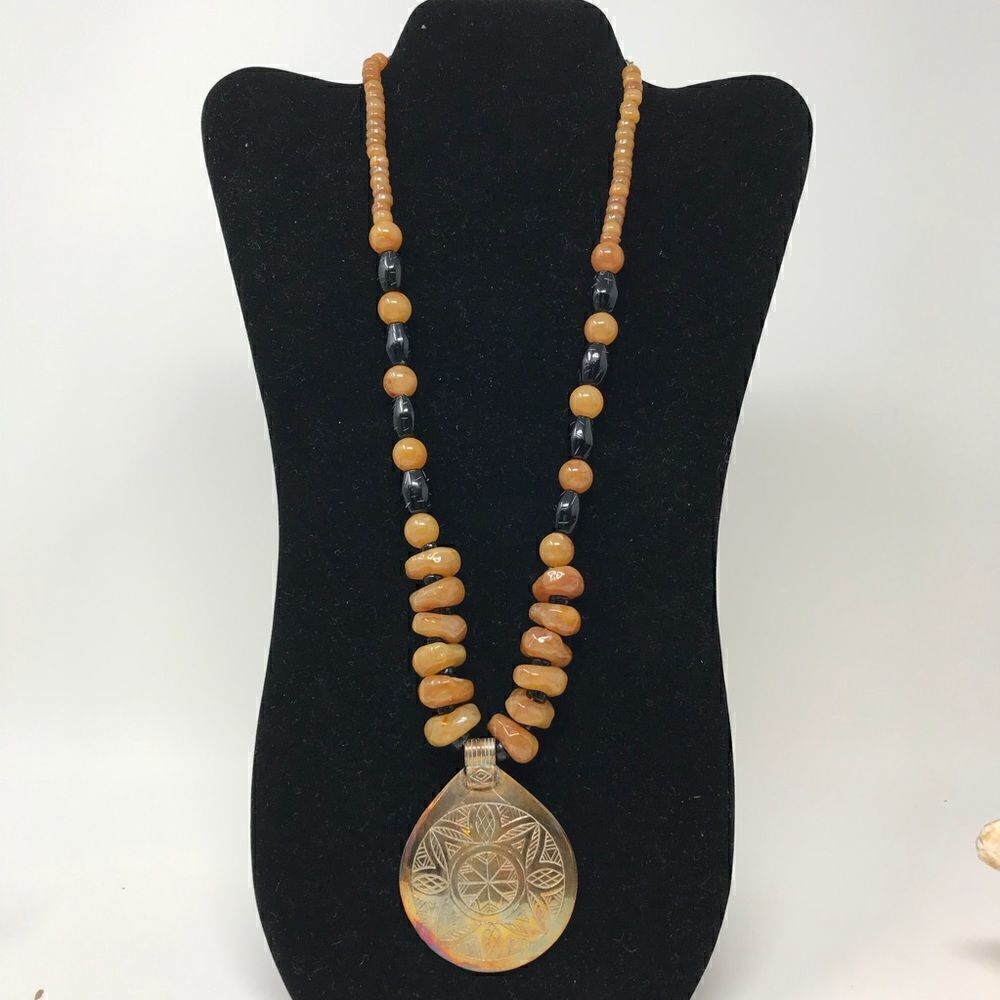 Vintage Brass pendent with butterscotch and black plastic beads necklace.